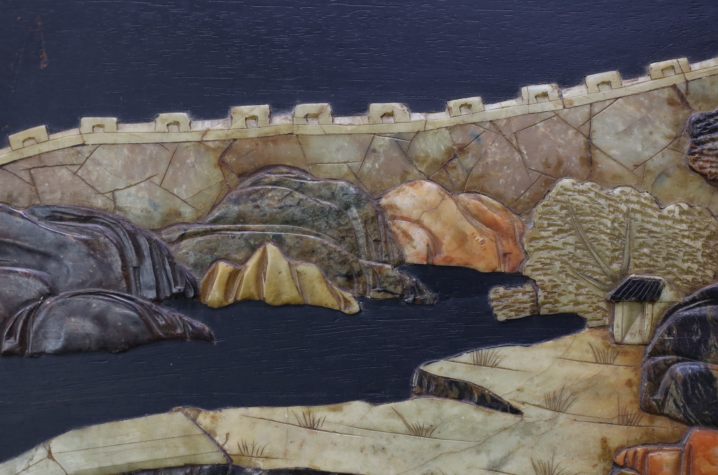 A pair of Chinese soapstone overlaid landscape panels, early 20th century, each panel including frame 33.5cm x 59cm